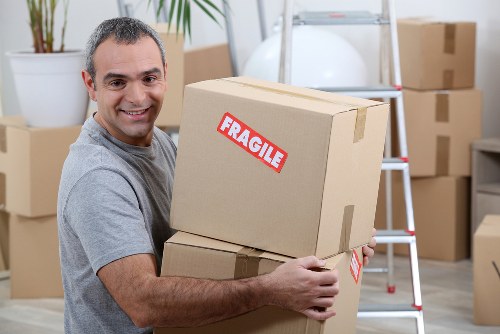 Furniture collection team handling bulky items in Swiss Cottage residential property