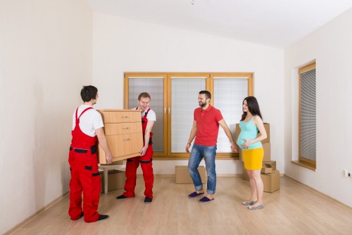 Moving team loading household items into a van