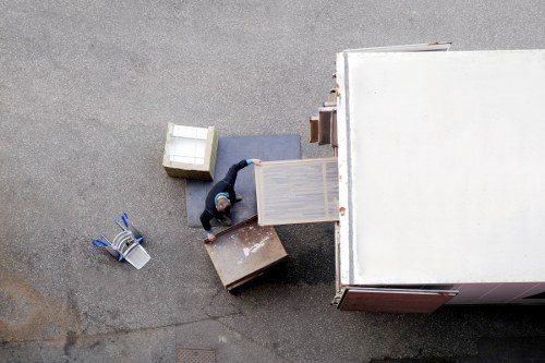 Moving team handling furniture near residential flats in Swiss Cottage