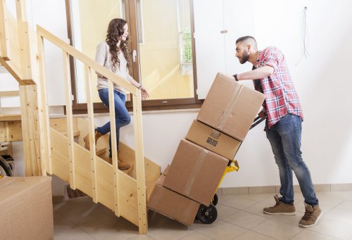 Packed boxes and furniture prepared for a flat move in Swiss Cottage