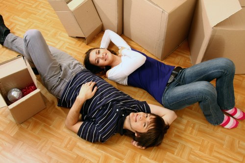 Student furniture and boxes being carried down stairs in Swiss Cottage
